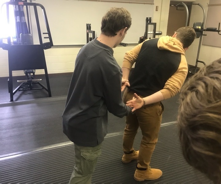 students practicing handcuffing