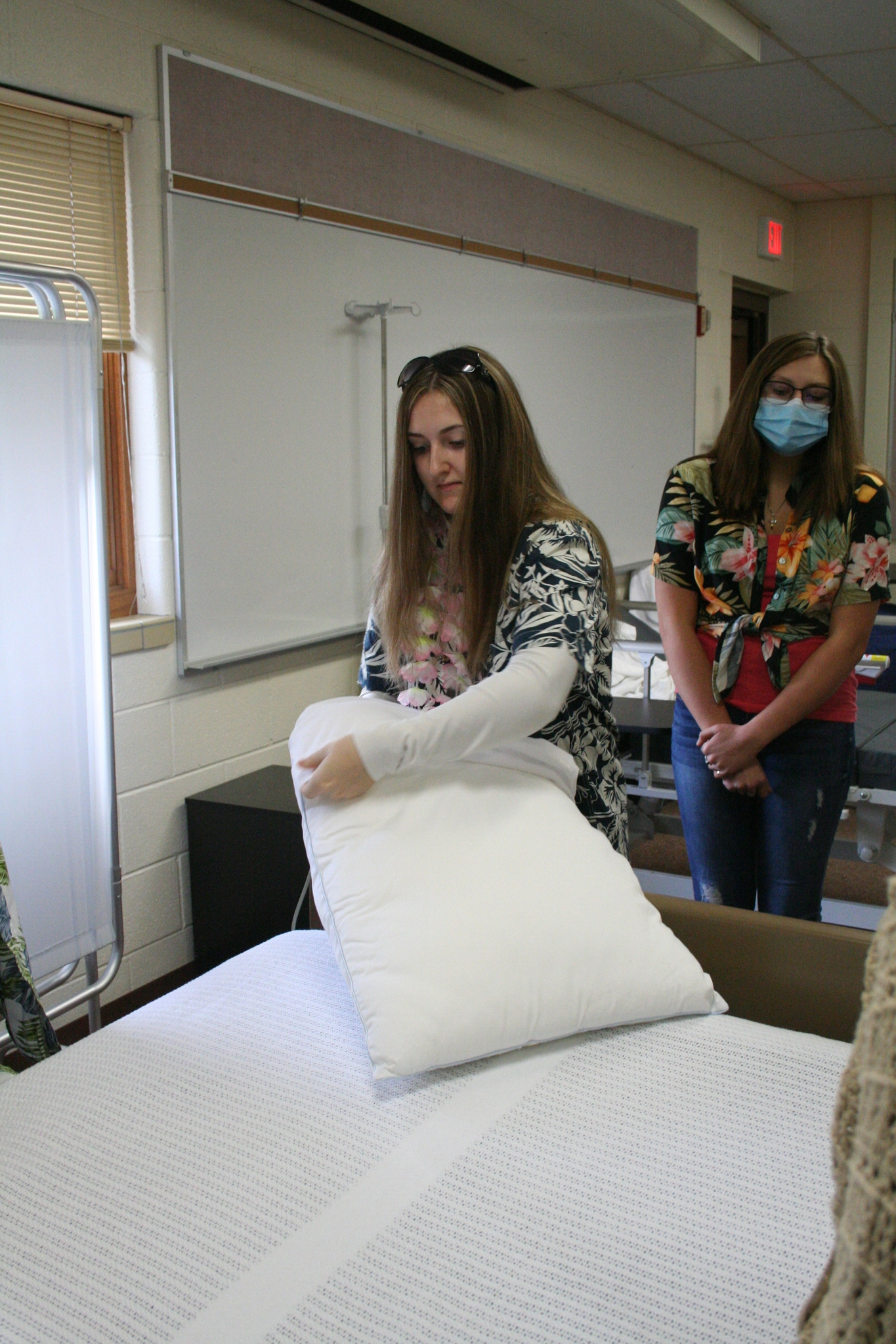 Medical Occupations students learning way to put on pillow case in hospital settings