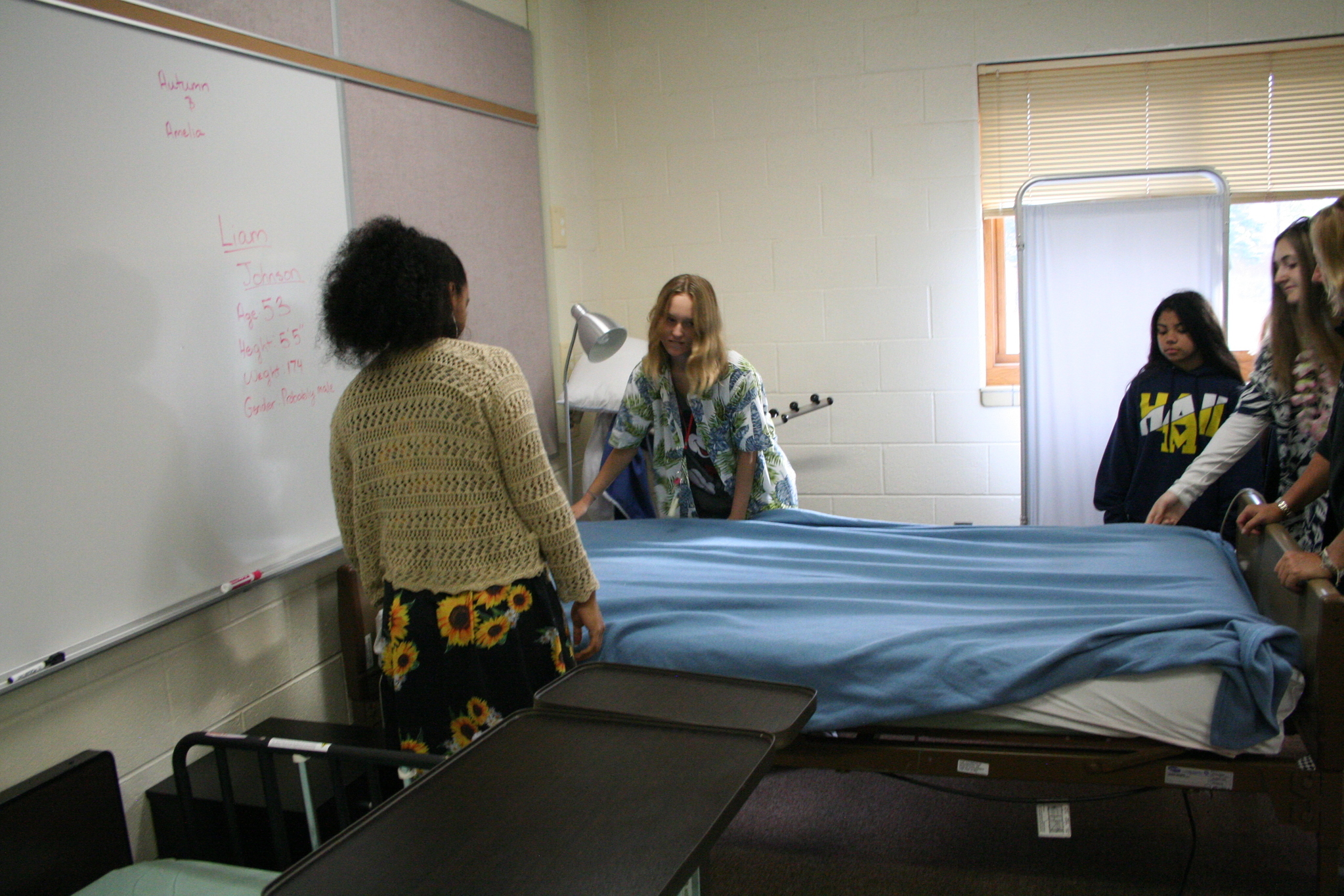 Medical Occupations students practicing making hospital beds