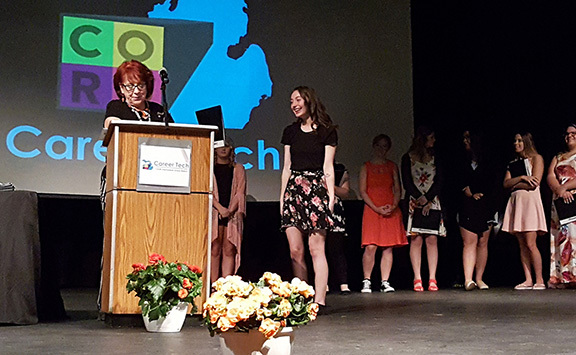 student receiving award from Cosmetology