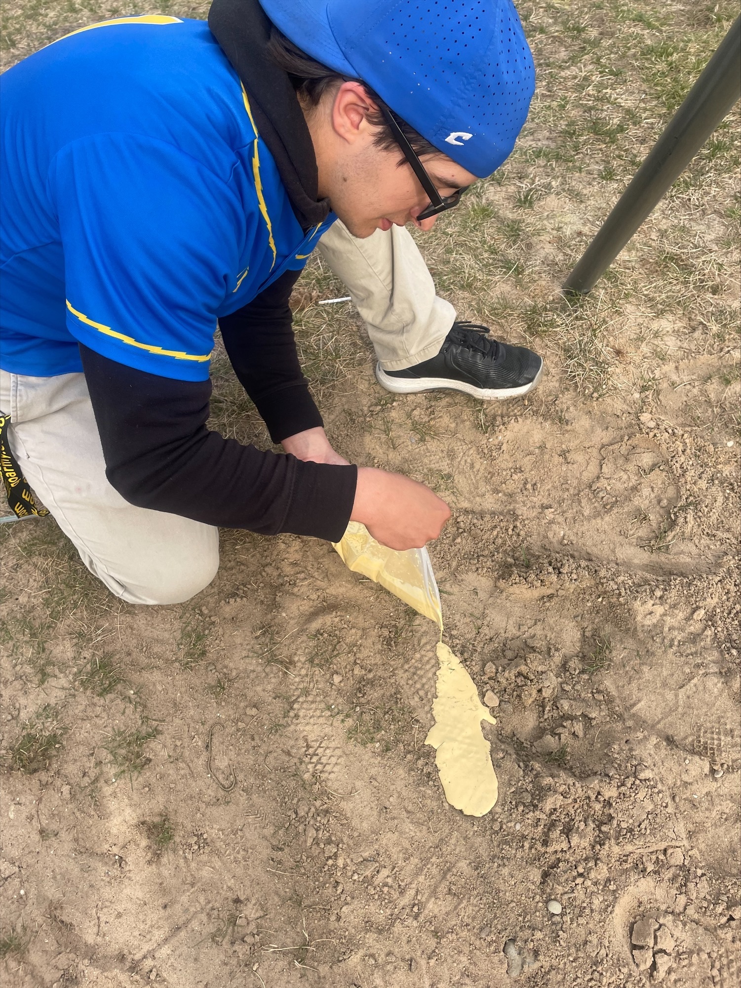 public safety student pouring his cast into his footprint