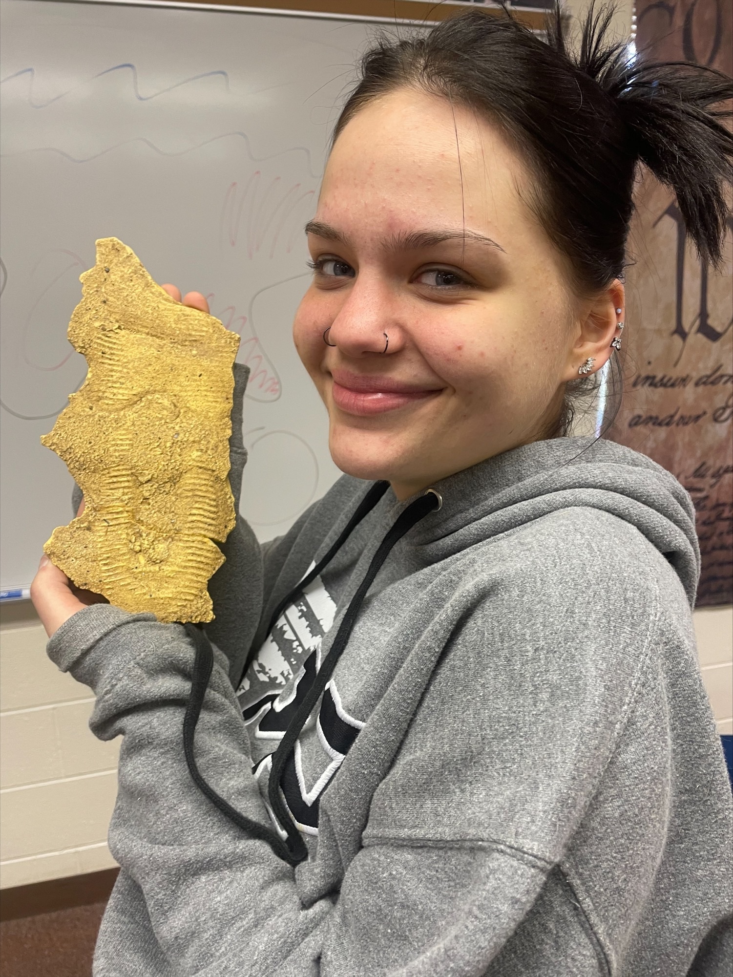public safety student posing with her shoe imprint cast