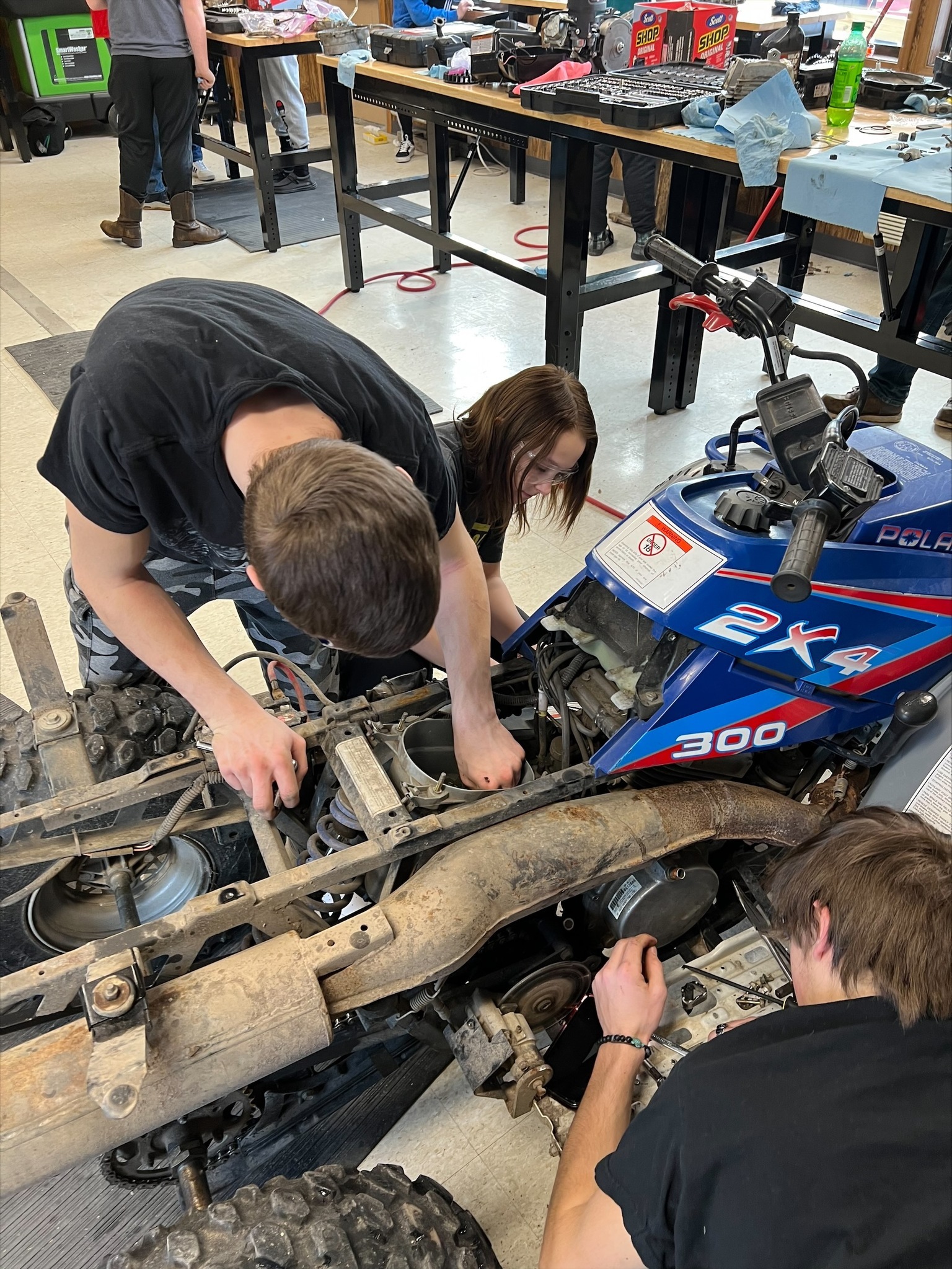 rec engine students working on a 4 wheeler