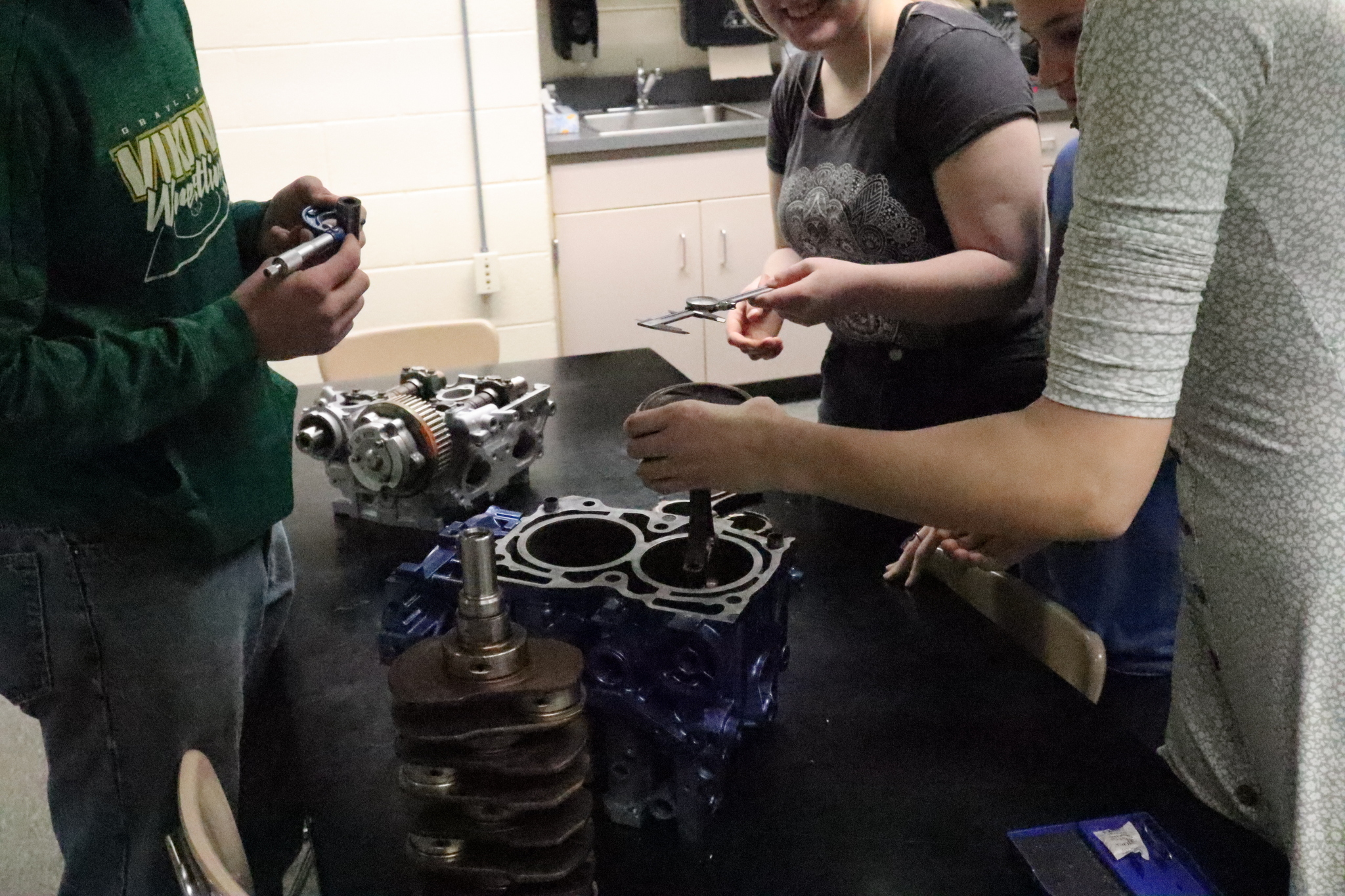 auto students working on car parts