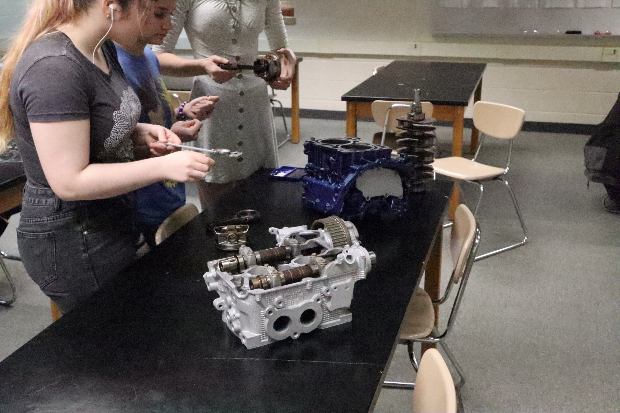 auto students working on car parts
