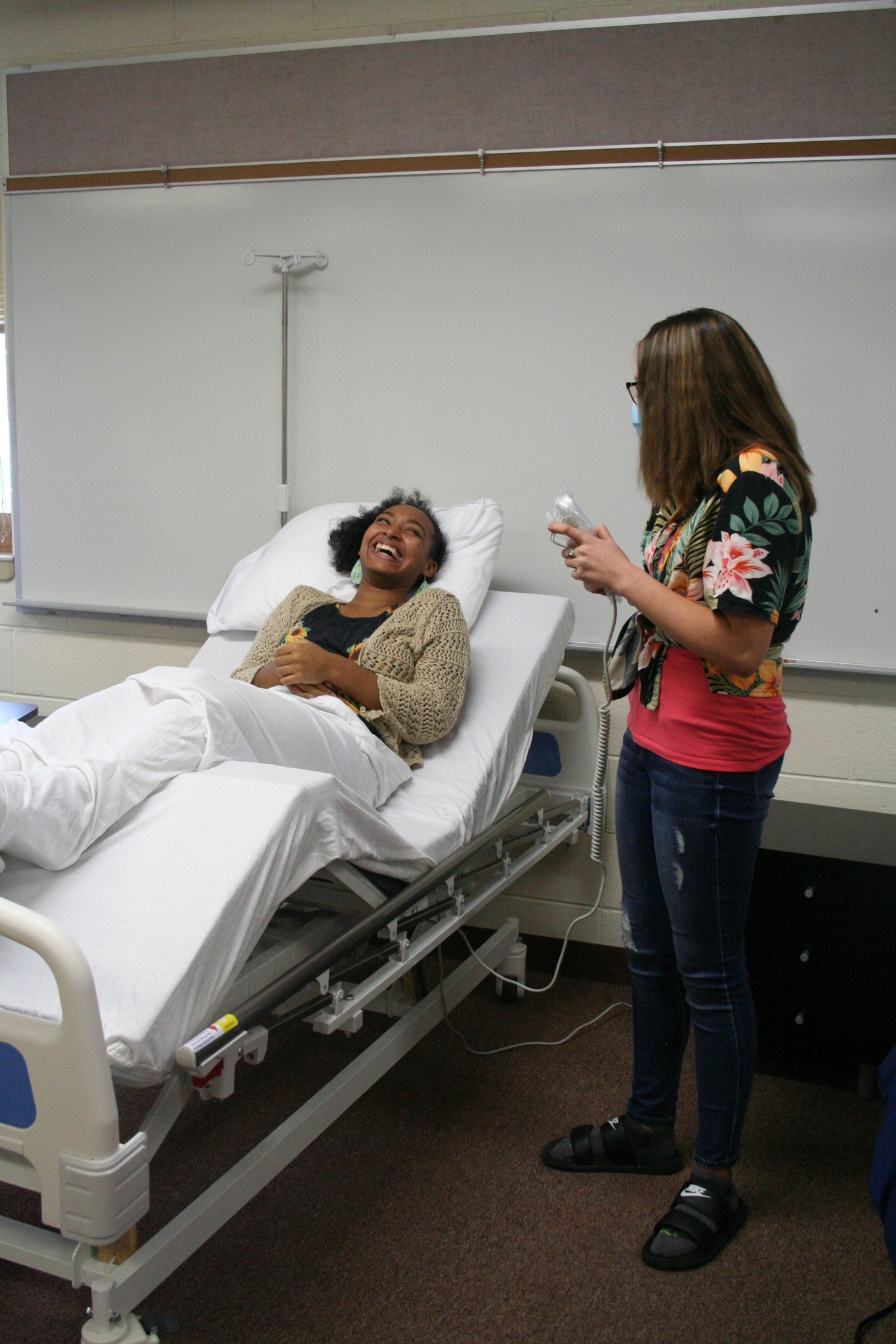Medical Occupations students learning the bed controls and positioning